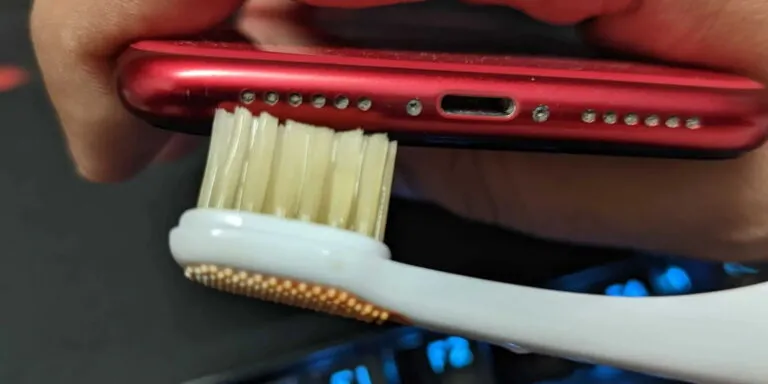 cleaning dirty iphone speaker with toothbrush